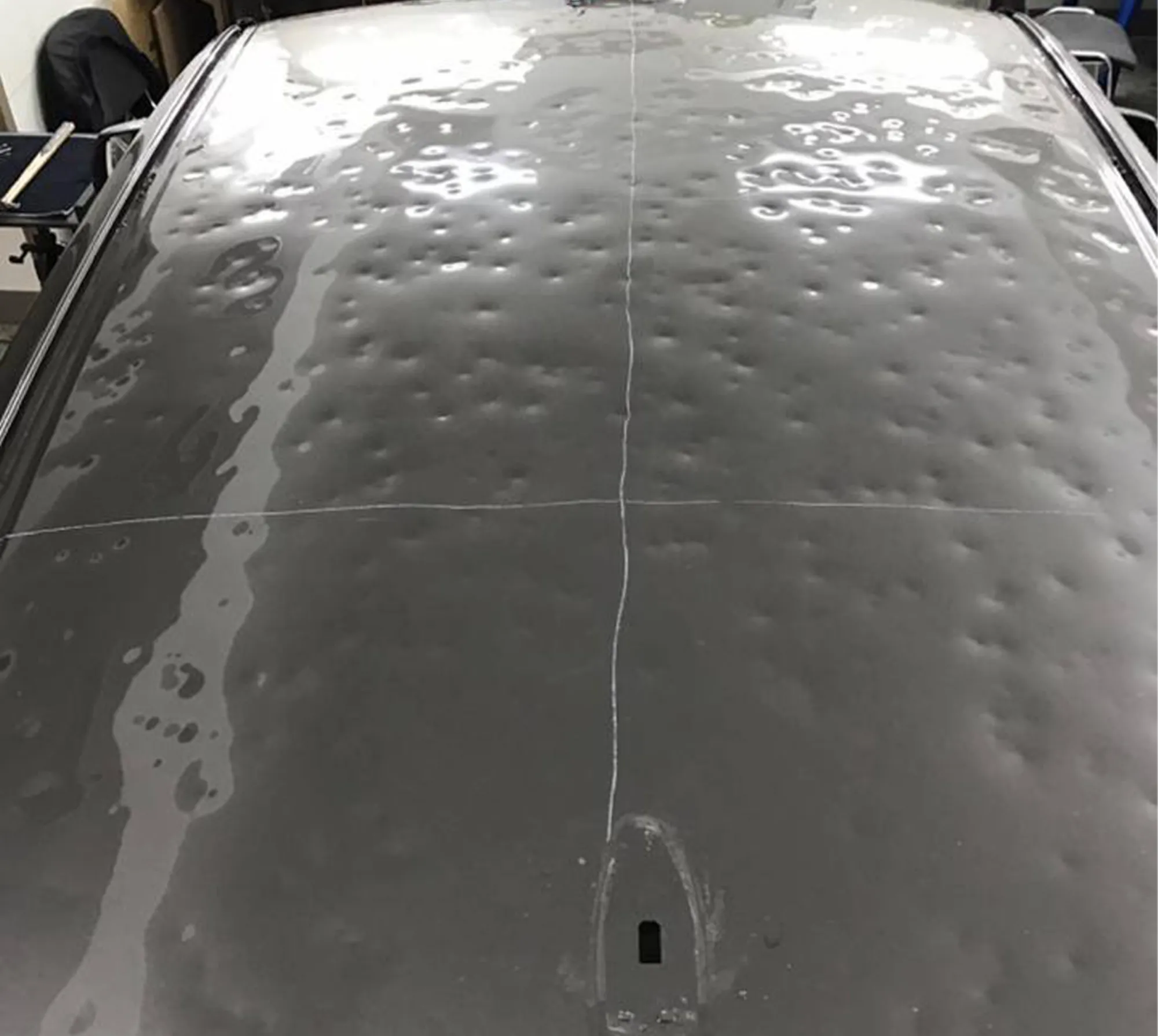 Hail damaged panel before repair
